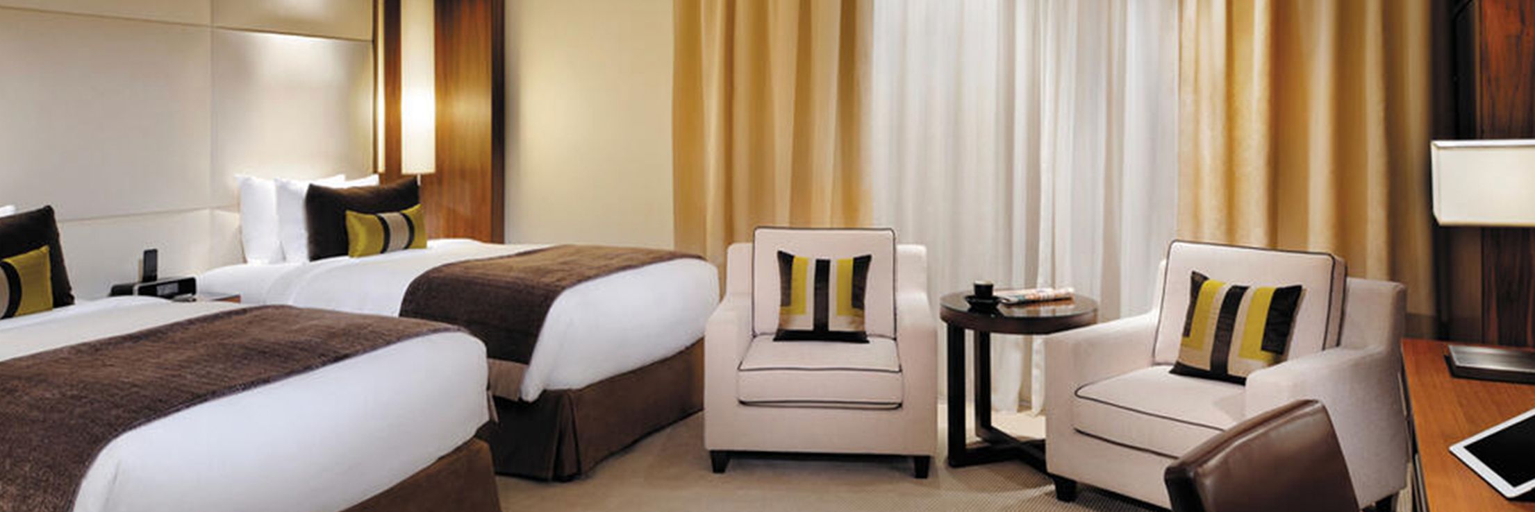 Two beds with seating and desk space